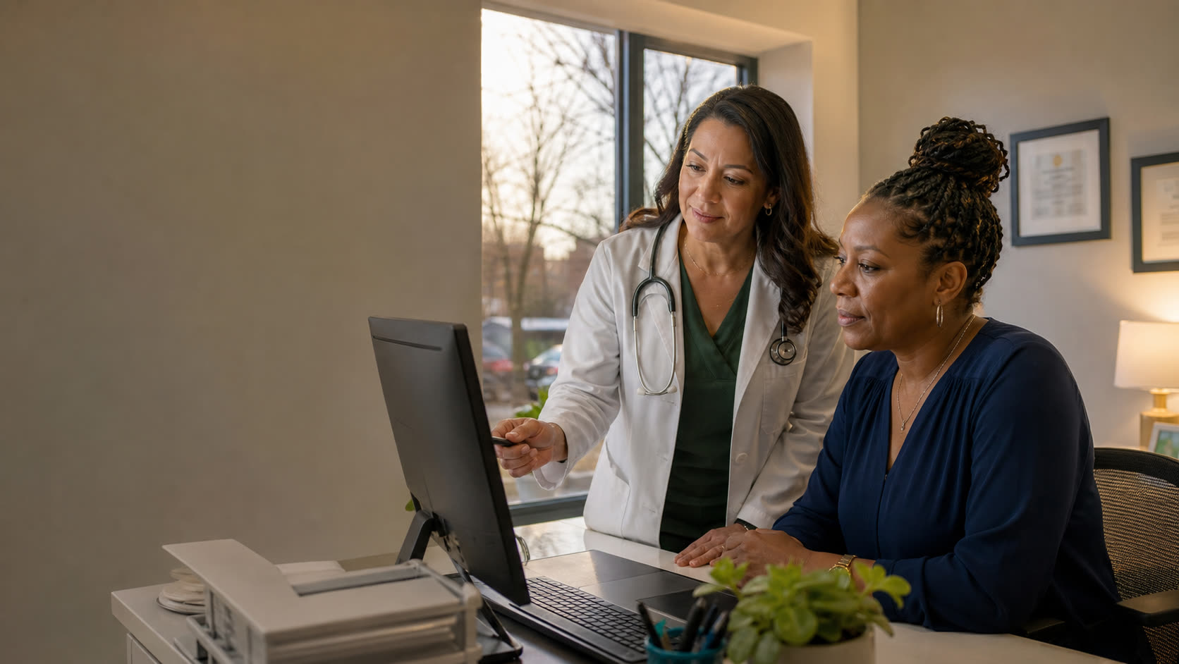 A physician-owner and practice manager reviewing an organized business workflow together after patient hours.